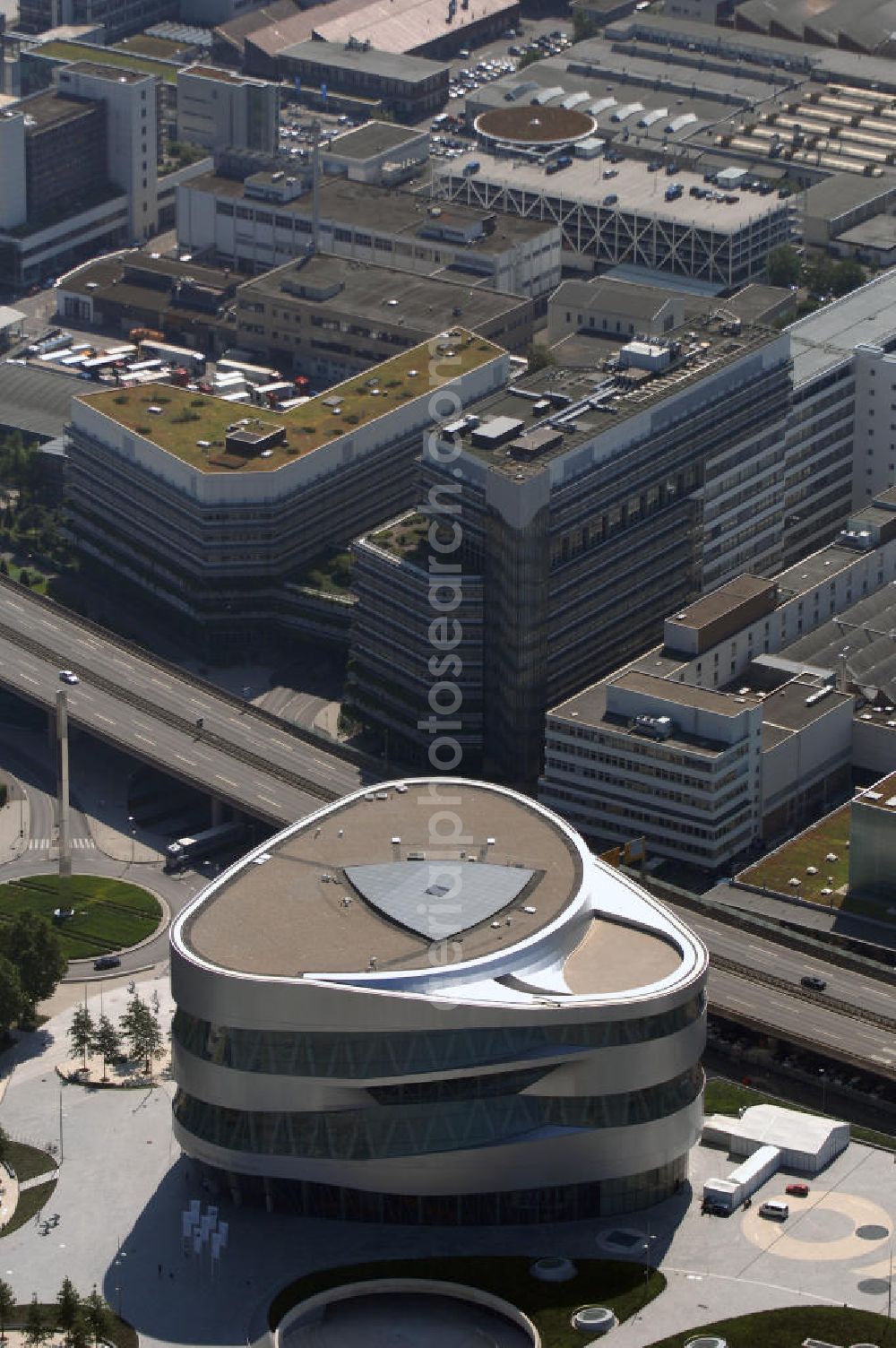 Aerial photograph Stuttgart - Blick auf die Mercedes-Benz Welt in Stuttgart-Bad Cannstadt. Es ist ein Kundenzentrum der Firma Mercedes-Benz. Es wurde am 19. Mai 2006 eröffnet und besteht aus dem neuen Mercedes-Benz-Museum und dem Mercedes-Benz-Center. Das Areal liegt direkt vor dem Haupttor des Daimler-Werks Untertürkheim an der B 14 auf einem künstlich aufgeschütteten Hügel gegenüber dem Gottlieb-Daimler-Stadion. Kontakt: Mercedesstr. 100, 70372 Stuttgart, Tel. +49 (0)711 17 30 000, Fax +49 (0)711 17 30 400, Email mercedes-benz-museum@daimler.com