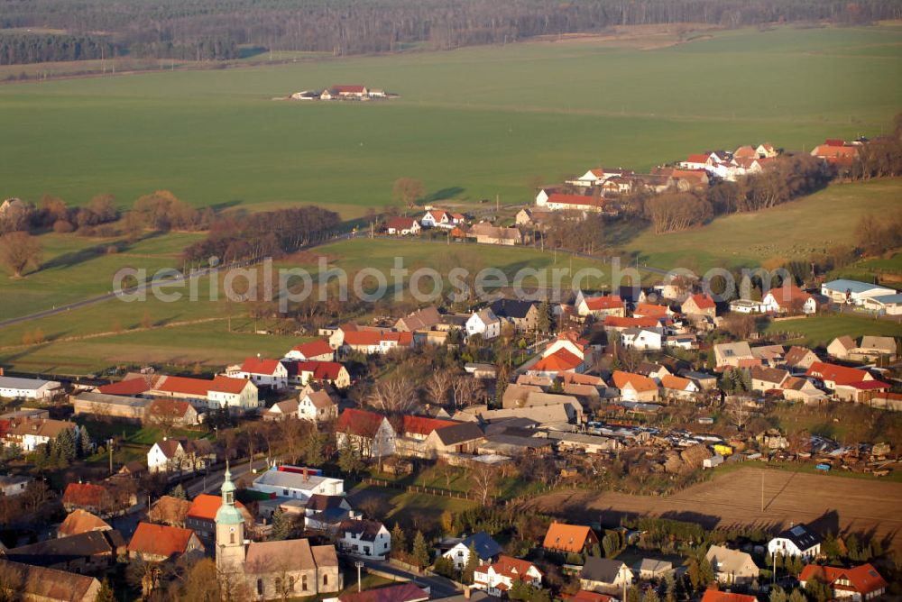 Mockrehna from the bird's eye view: Blick auf den Ort Audenhain mit der St. Marien Kirche. Am südlichen Rand der Dübener Heide liegt der OT Audenhain der Gemeinde Mockrehna. Im Vordergrund die St. Marien Kirche, im Kern eine spätromanische Saalkirche, die mehrfach umgebaut wurde. (Evangelische Kirchgemeinde Audenhain, Pfrn. Frau Preisler, Dorfstr. 156, 04838 Audenhain, Tel.: 034244/51361, Fax: 034244/51362)