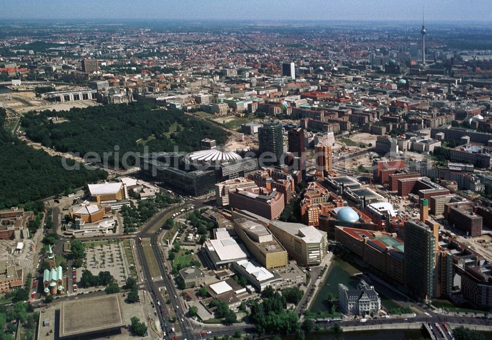 Berlin from the bird's eye view: From Potsdamer Platz in Berlin-Mitte with the shopping center Potsdamer Platz Arcades, the musical theaters, the State Library, the Philharmonic and the Chamber Music Hall and the Museums and Galleries of the Cultural Forum, we look towards the government district and Alexanderplatz. There we see the landmarks of the capital the Berlin TV Tower, the International Trade Centre at Friedrichstrasse, the skyscraper of the Charité 'and the Reichstag building and the new construction of the Bundestag