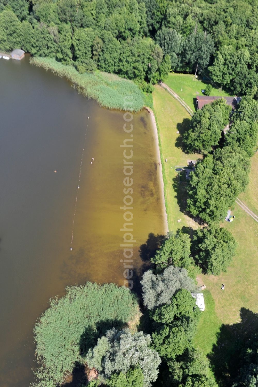 Leuengarten from above - View of the lake Rudow near Leuengarten in the state of Brandenburg. Rudower Lake is an elongated body of water in the Prignitz in the far northwestern corner of Brandenburg. The lake has two swimming areas - at Lenzen and at the village Leuengarden - as well as a camping ground and is also popular with anglers. Faunisticly, it has a relevance as a bird nesting and roosting area among other things