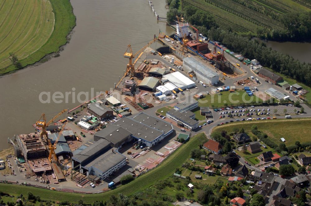 Aerial image Wewelsfleth - Blick auf eine Schiffswerft in Wewelsfleth. Die Peters Schiffbau GmbH ist ein Traditionsunternehmen und der größte Arbeitgeber der Gemeinde. Seit 1871 ist die Werft von Jürgen Peters die alleinige Werft in Wewelsfleth. Das mittelständische Unternehmen ist direkt an der Störmündung zu Elbe ansässig und baut dort Schiffe mit einer Länge bis zu 137,80m für internationale Kunden. Kontakt: Am Hafen 6, 25599 Wewelsfleth, Fax +49 4829 71 290, Tel. +49 4829 71 0, Homepage