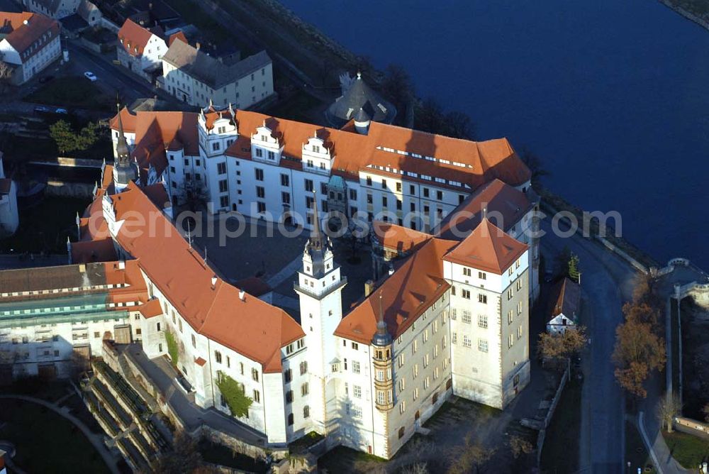 Torgau from the bird's eye view: Blick auf Schloss Hartenfels an der Elbe. Es ist ein prachtvolles Renaissanceschloss in der Stadt Torgau im Freistaat Sachsen.Der Schlossbau wurde im 15. Jahrhundert von Konrad Pflüger, einem Schüler Arnolds von Westfalen begonnen und im 16. Jahrhundert von Konrad Krebs fortgeführt. Es war einer der Hofhaltungssitze der sächsischen Kurfürsten aus dem Hause Wettin und ist das größte vollständig erhaltene Schloss der Frührenaissance Deutschlands. Im Schlossinneren befindet sich der Wendelstein, eine fast 20 Meter hohe freitragende steinerne Wendeltreppe. Die Kapelle von Schloss Hartenfels war der erste protestantische Kirchenbau der Welt. Sie wurde 1544 von Martin Luther eingeweiht. Nachdem die albertinischen Wettiner im 16. Jahrhundert ihren Hofhaltungssitz dauerhaft nach Dresden verlegten, wurde das Schloss hauptsächlich als Verwaltungsgebäude genutzt. 1815 gelangte es an das Königreich Preußen und diente nunmehr der preußischen Verwaltung des neugebildeten Kreises Torgau.