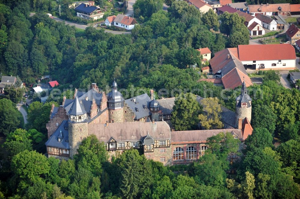 Aerial photograph Mansfeld - View of the castle Rammelburg in the homonymous district of the town Mansfeld in Saxony-Anhalt. It was built in the 13th Century and was used as a children's home and rehabilitation clinic at the time of the GDR. Today the building is vacant and unused