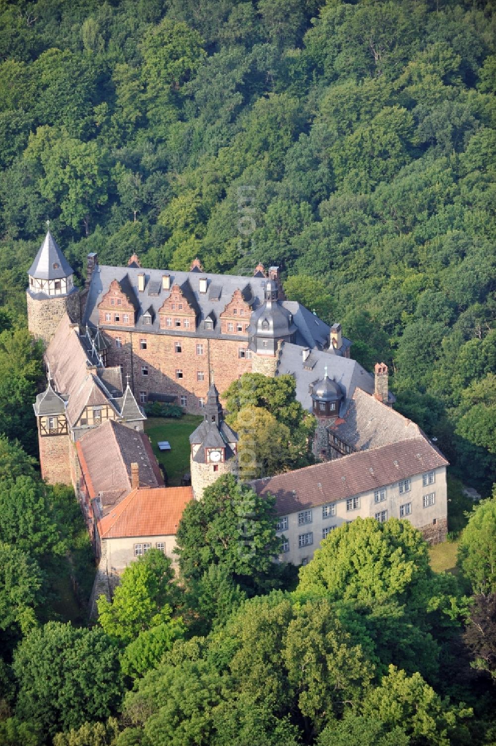 Aerial image Mansfeld - View of the castle Rammelburg in the homonymous district of the town Mansfeld in Saxony-Anhalt. It was built in the 13th Century and was used as a children's home and rehabilitation clinic at the time of the GDR. Today the building is vacant and unused