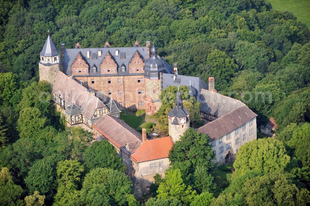 Aerial photograph Mansfeld - View of the castle Rammelburg in the homonymous district of the town Mansfeld in Saxony-Anhalt. It was built in the 13th Century and was used as a children's home and rehabilitation clinic at the time of the GDR. Today the building is vacant and unused