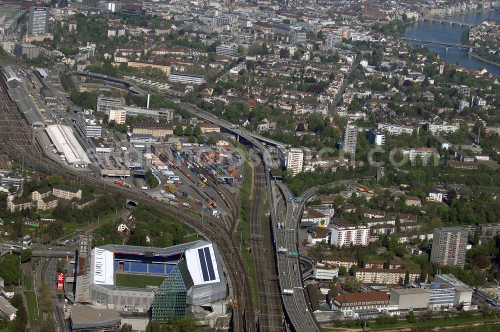 Aerial photograph Basel - Blick über die Stadt mit Stadion und Bahnhof. Der St. Jakob-Park (früher St. Jakob-Stadion, lokal Joggeli genannt) ist zur Zeit das grösste Fussballstadion der Schweiz und ist Teil des Sportzentrum St. Jakob. Es ist das Heimstadion des Fussballclub Basel (FCB). Es wurde von den Architekten Herzog & de Meuron von 1999 bis 2001 erstellt und hat ein Fassungsvermögen von 38500 Sitzplätzen. Es ist Austragungsort und Eröffnungsort der Europameisterschaft 2008. Zum St. Jakob-Park gehört auch der neu erbaute St.Jakob Turm mit Glasfassade.