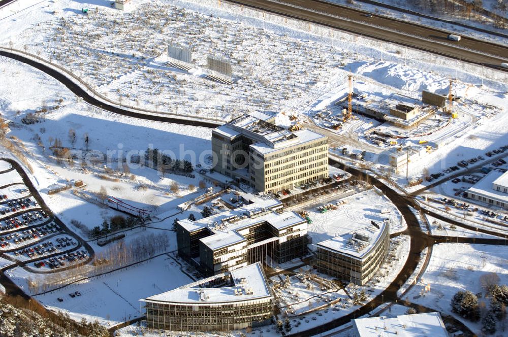 Dreilinden from the bird's eye view: Blick auf den verschneiten Erweiterungsbaustelle Europapark Dreilinden bei der Waldsiedlung Dreilinden nahe der brandenburgischen Gemeinde Kleinmachnow (Landkreis Potsdam-Mittelmark) südwestlich von Berlin. Dreilinden ist der Name eines Forstes und einer Kolonie und war besonders bekannt als Bezeichnung für die frühere Grenzübergangsstelle Drewitz. Der ab 1990 errichtete Europapark ist ein Gewerbepark auf dem ehemaligen Gelände der wichtigsten Transitstrecke nach Westen und Süden (Checkpoint Bravo).