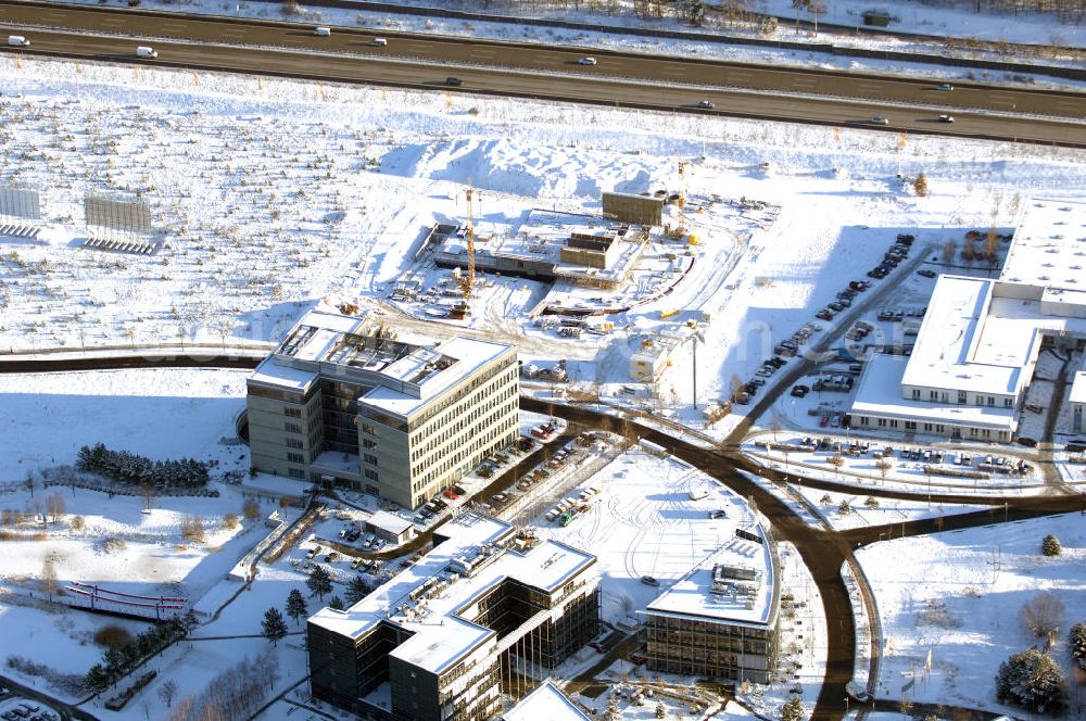 Aerial image Dreilinden - Blick auf den verschneiten Erweiterungsbaustelle Europapark Dreilinden bei der Waldsiedlung Dreilinden nahe der brandenburgischen Gemeinde Kleinmachnow (Landkreis Potsdam-Mittelmark) südwestlich von Berlin. Dreilinden ist der Name eines Forstes und einer Kolonie und war besonders bekannt als Bezeichnung für die frühere Grenzübergangsstelle Drewitz. Der ab 1990 errichtete Europapark ist ein Gewerbepark auf dem ehemaligen Gelände der wichtigsten Transitstrecke nach Westen und Süden (Checkpoint Bravo).