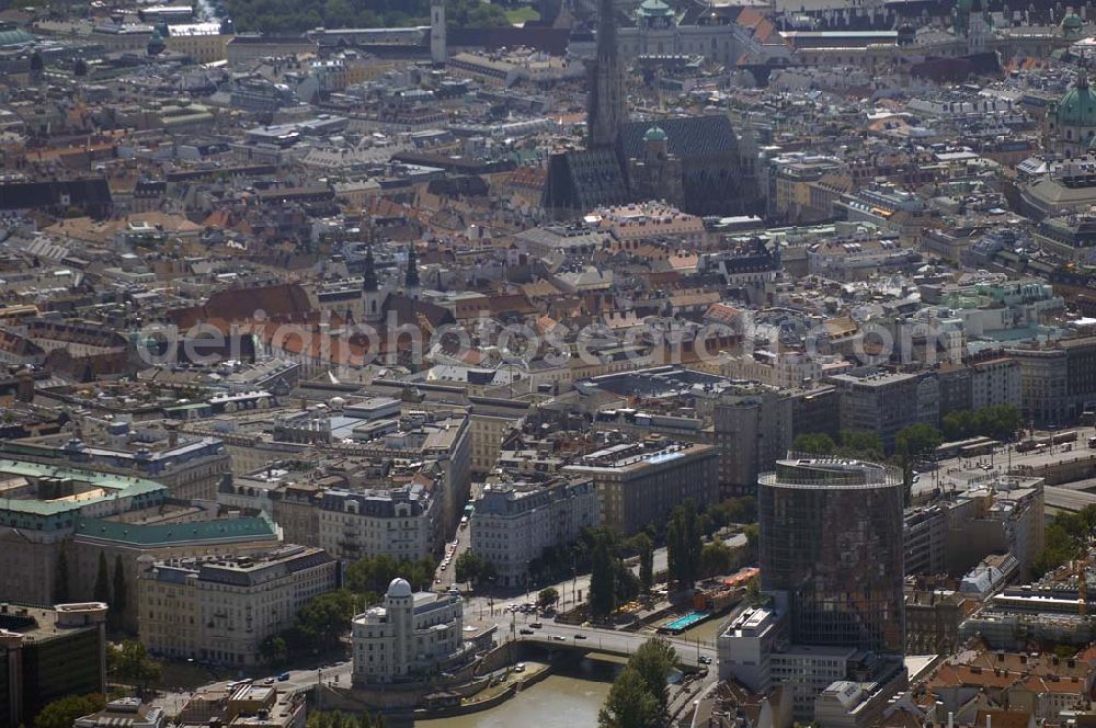 Aerial photograph Wien - Blick auf die Wiener Altstadt mit dem Stephansdom im Hintergrund. Vorne im Bild ist das Volksbildungshaus mit Sternwarte, die Urania, am Donaukanal zu sehen. Gegenüber steht der 75 Meter hohe UNIQA-Tower.