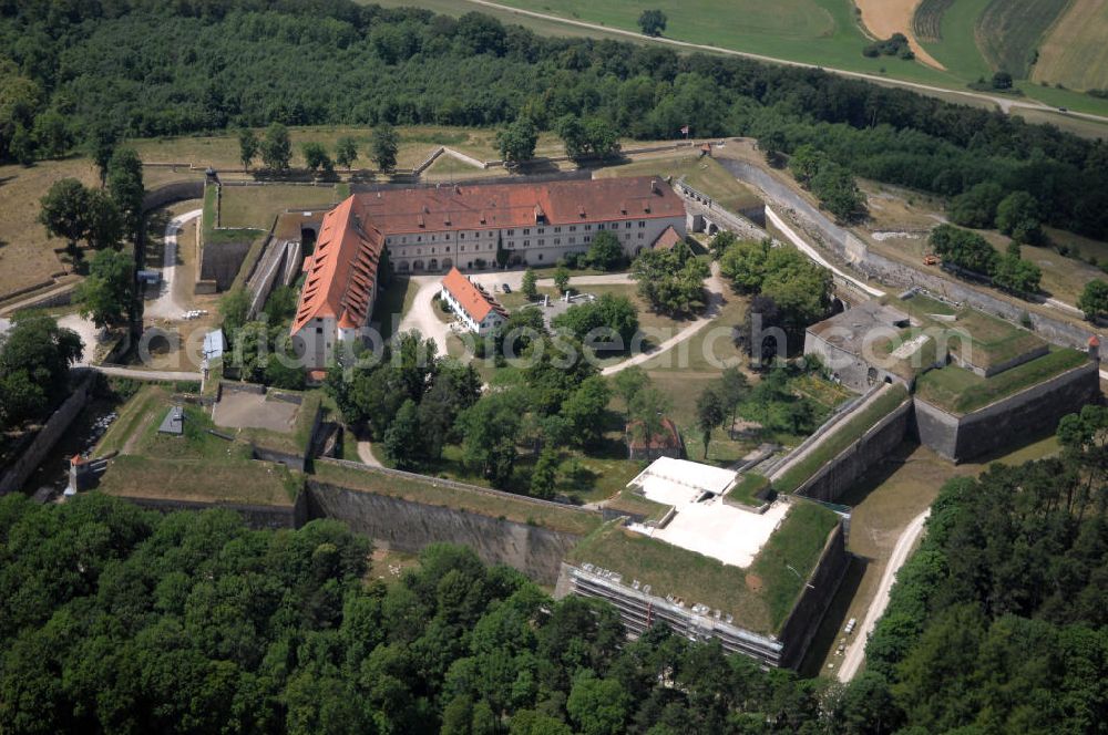 Aerial photograph Weißenburg - Blick auf die Wülzburg als Ortsteil von Weißenburg. Das Gebäude auf der mit 650 Meter höchsten Bergkuppe der südlichen Frankenalb war ursprünglich ein Benediktinerkloster St. Petrus und Paulus zu Wülzburg. Es wurde 1588 vom Bauherrn Markgraf Georg Friedrich von Brandenburg-Ansbach und -Kulmbach in eine Festung umgewandelt. Seit 1882 ist die Festung in Besitz der Stadt Weißenburg. Im Ersten Weltkrieg wurde die Wülzburg als Kriegsgefangenenlager genutzt, während des Zweiten Weltkrieges war sie ein Internierungslager, danach ein Massen-Flüchtlingslager. Heute beheimatet der Schlossbau u. a. eine Schule mit Internat für soziale Frauenberufe, die inzwischen von den Rummelsberger Anstalten geleitet wird.