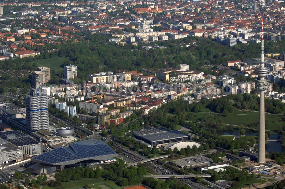 Aerial photograph München - Blick auf die BMW-Welt und den Olympiaturm in München. Der BMW-Vierzylinder ist das Hauptverwaltungsgebäude und Wahrzeichen des Autoherstellers. Davor befindet sich das BMW Museum, welches 1973 eröffnet wurde. Kontakt: BMW Kundenbetreuung, 80788 München, Tel. +49(0)180 2324252, Fax +49(0)180 2123484, Email: kundenbetreuung@bmw.de