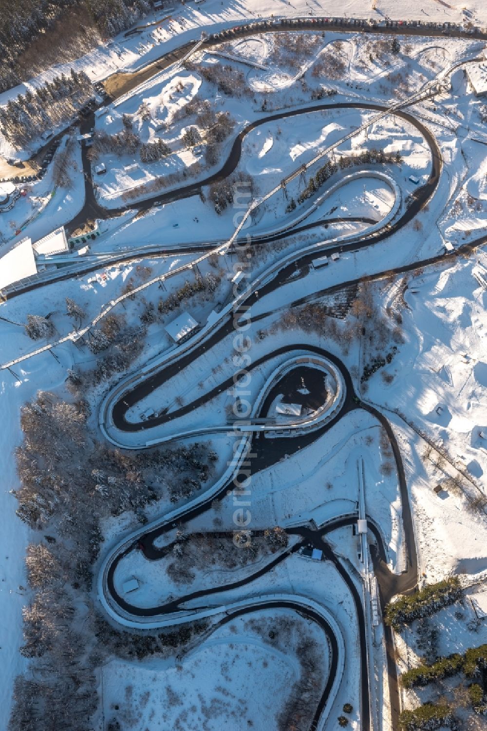 Winterberg from the bird's eye view: The snow - covered bobsled and luge run in Winterberg in the district Hochsauerlandkreis HSK in the state North Rhine-Westphalia. Operator is the recreation and sports center Winterberg GmbH