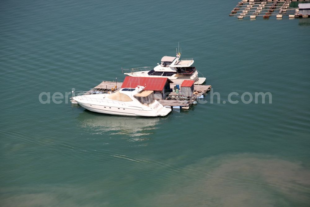 Ratsada from above - Boats and House Boat in the Bay Ao Tha Rua in front of the city Ratsada on the island of Phuket in Thailand