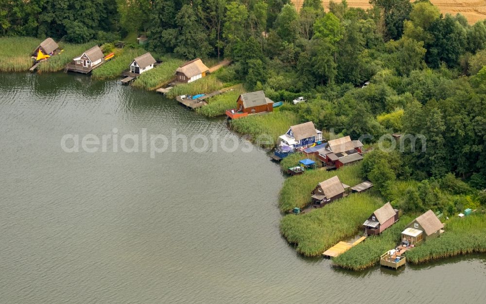 Krakow am See from the bird's eye view: Boat House ranks with the recreational marine jetties and boat mooring area on the banks of lake Krakower See in Krakow am See in the state Mecklenburg - Western Pomerania