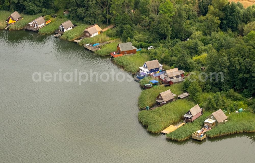 Aerial image Krakow am See - Boat House ranks with the recreational marine jetties and boat mooring area on the banks of lake Krakower See in Krakow am See in the state Mecklenburg - Western Pomerania