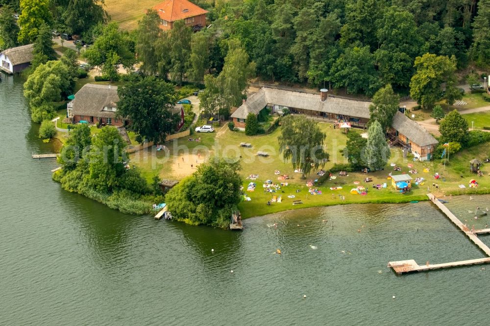 Aerial photograph Krakow am See - Boat House ranks with the recreational marine jetties and boat mooring area on the banks of lake Krakower See in Krakow am See in the state Mecklenburg - Western Pomerania