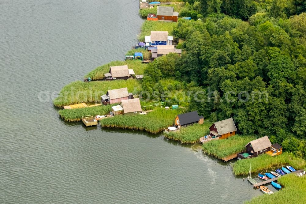 Krakow am See from the bird's eye view: Boat House ranks with the recreational marine jetties and boat mooring area on the banks of lake Krakower See in Krakow am See in the state Mecklenburg - Western Pomerania