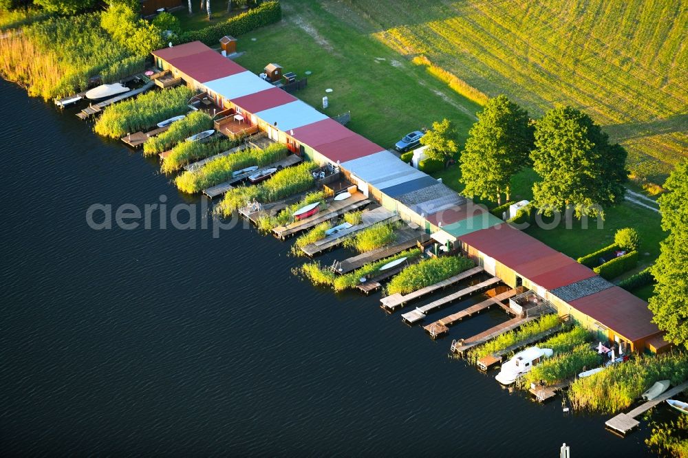 Aerial image Schillersdorf - Boat House ranks with the recreational marine jetties and boat mooring area on the banks of Leppinsee in Schillersdorf in the state Mecklenburg - Western Pomerania, Germany