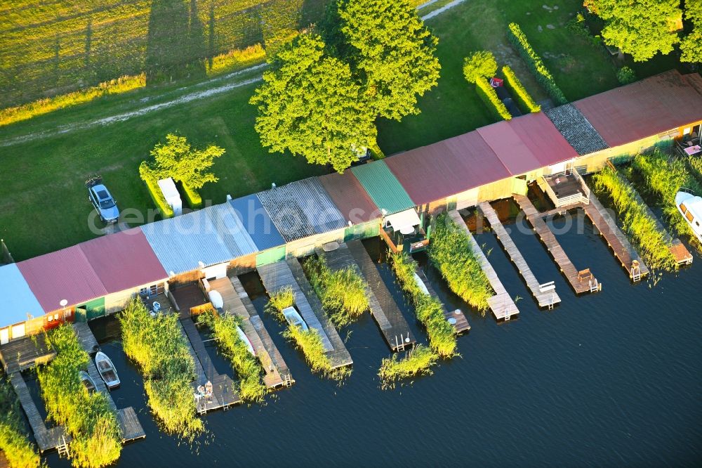 Aerial photograph Schillersdorf - Boat House ranks with the recreational marine jetties and boat mooring area on the banks of Leppinsee in Schillersdorf in the state Mecklenburg - Western Pomerania, Germany