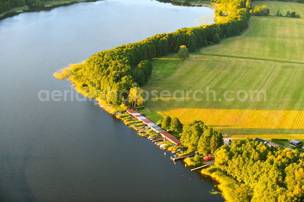 Aerial image Schillersdorf - Boat House ranks with the recreational marine jetties and boat mooring area on the banks of Leppinsee in Schillersdorf in the state Mecklenburg - Western Pomerania, Germany