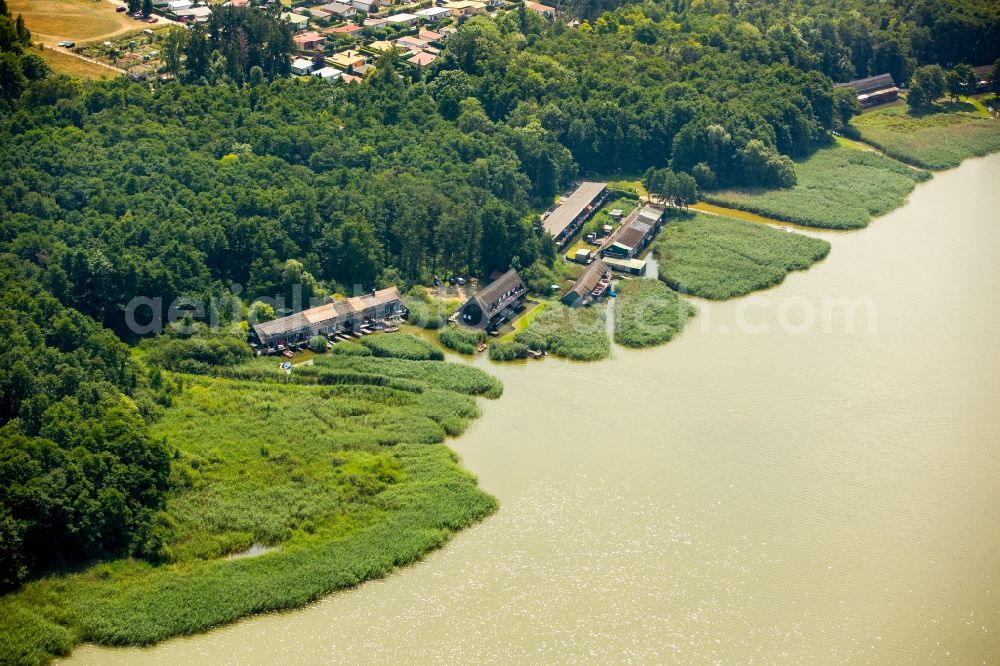 Seedorf from the bird's eye view: Boat House ranks with the recreational marine jetties and boat mooring area on the banks des Malchiner Sees in Seedorf in the state Mecklenburg - Western Pomerania