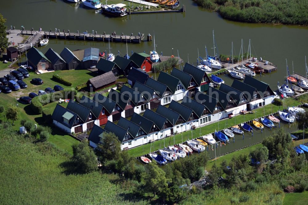 Aerial image Ahrenshoop - Boat House ranks with the recreational marine jetties and boat mooring area on the banks of see Saaler Bodden in Ahrenshoop in the state Mecklenburg - Western Pomerania