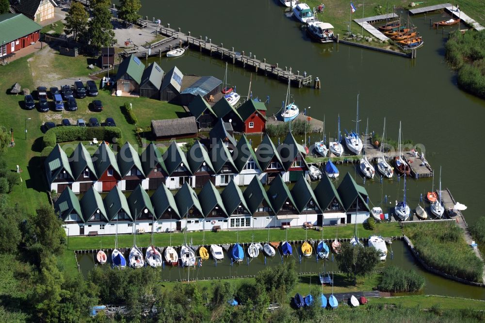 Aerial photograph Ahrenshoop - Boat House ranks with the recreational marine jetties and boat mooring area on the banks of see Saaler Bodden in Ahrenshoop in the state Mecklenburg - Western Pomerania