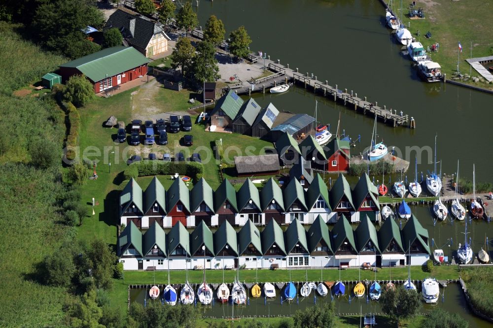 Ahrenshoop from above - Boat House ranks with the recreational marine jetties and boat mooring area on the banks of see Saaler Bodden in Ahrenshoop in the state Mecklenburg - Western Pomerania