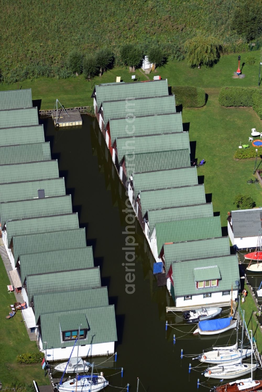 Aerial image Ahrenshoop - Boat House ranks with the recreational marine jetties and boat mooring area on the banks of see Saaler Bodden in Ahrenshoop in the state Mecklenburg - Western Pomerania