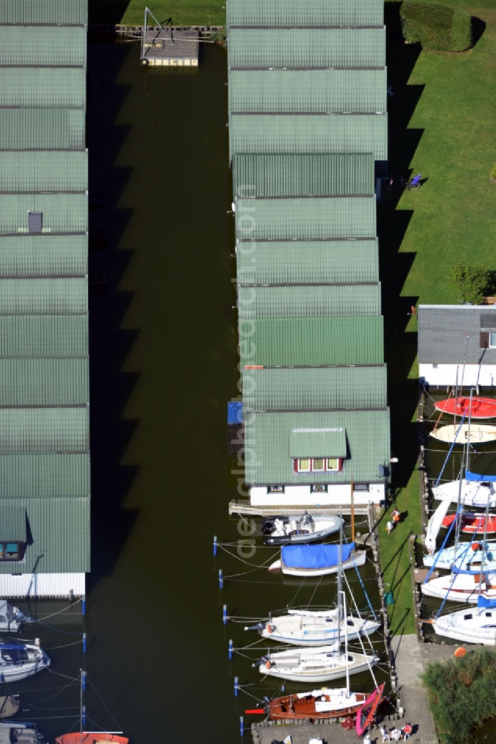 Ahrenshoop from above - Boat House ranks with the recreational marine jetties and boat mooring area on the banks of see Saaler Bodden in Ahrenshoop in the state Mecklenburg - Western Pomerania