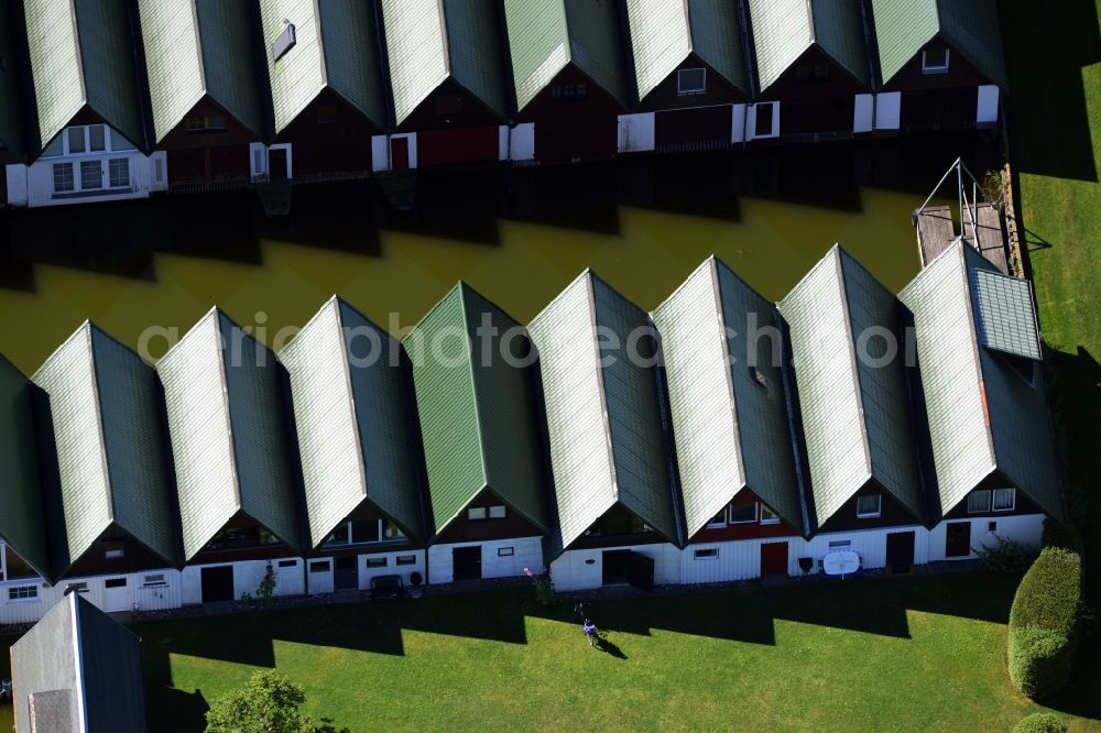 Ahrenshoop from the bird's eye view: Boat House ranks with the recreational marine jetties and boat mooring area on the banks of see Saaler Bodden in Ahrenshoop in the state Mecklenburg - Western Pomerania