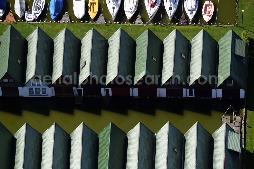 Aerial photograph Ahrenshoop - Boat House ranks with the recreational marine jetties and boat mooring area on the banks of see Saaler Bodden in Ahrenshoop in the state Mecklenburg - Western Pomerania