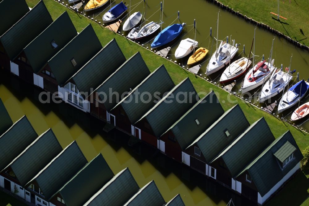 Aerial photograph Ahrenshoop - Boat House ranks with the recreational marine jetties and boat mooring area on the banks of see Saaler Bodden in Ahrenshoop in the state Mecklenburg - Western Pomerania