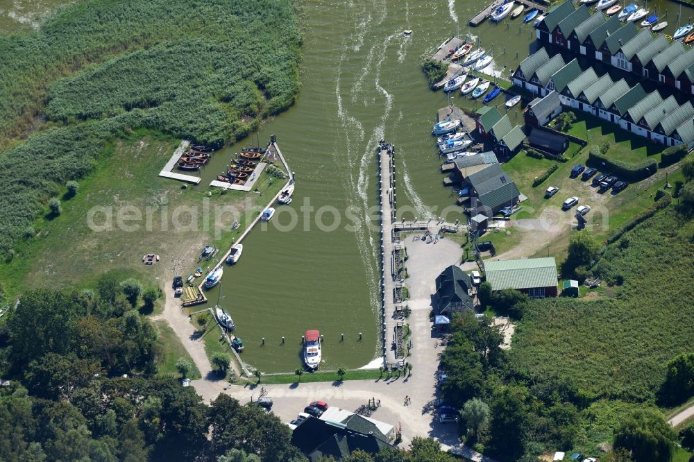 Aerial photograph Ahrenshoop - Boat House ranks with the recreational marine jetties and boat mooring area on the banks of see Saaler Bodden in Ahrenshoop in the state Mecklenburg - Western Pomerania