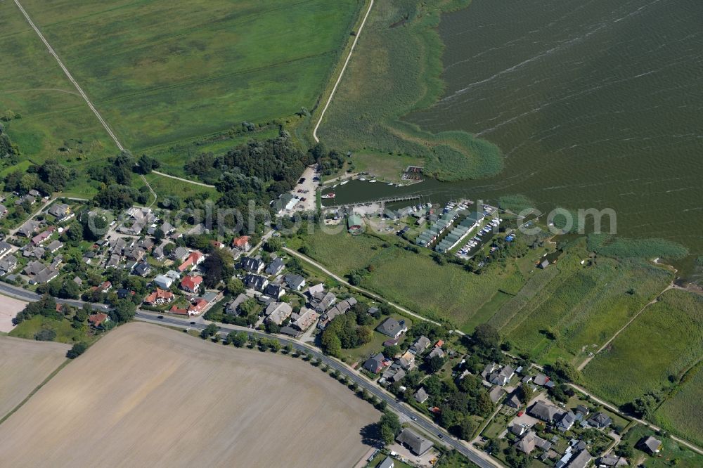 Aerial image Ahrenshoop - Boat House ranks with the recreational marine jetties and boat mooring area on the banks Saaler Bodden in the district Althagen in Ahrenshoop in the state Mecklenburg - Western Pomerania