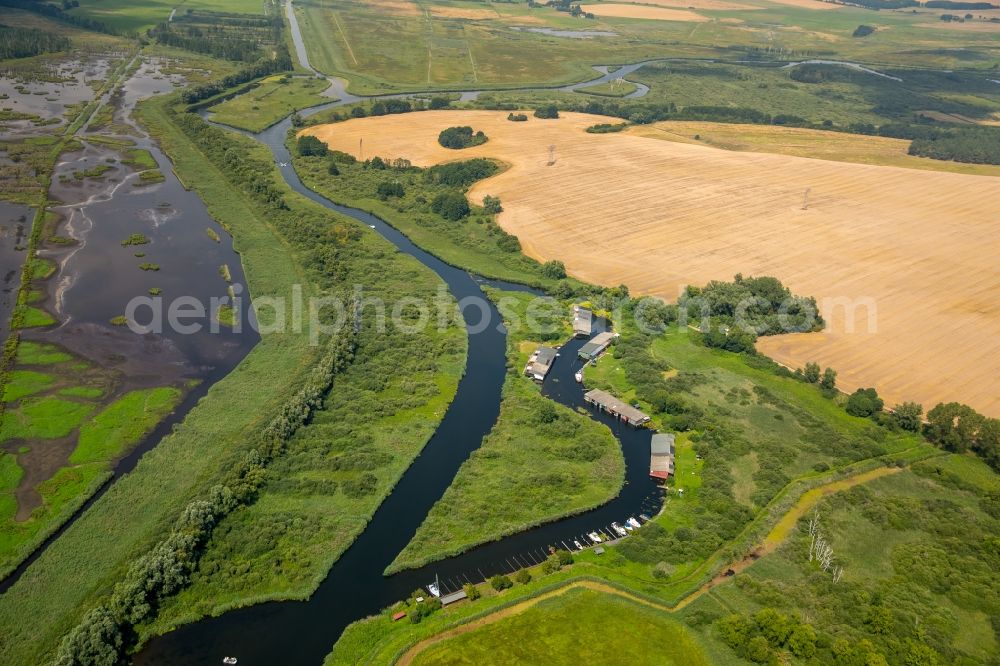 Verchen from the bird's eye view: Boat Houses with the recreational marine jetties and boat mooring area on the banks of the river Peene in Verchen in the state Mecklenburg - Western Pomerania