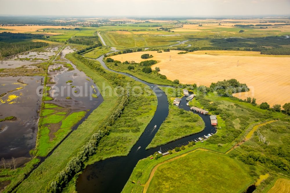 Verchen from the bird's eye view: Boat Houses with the recreational marine jetties and boat mooring area on the banks of the river Peene in Verchen in the state Mecklenburg - Western Pomerania