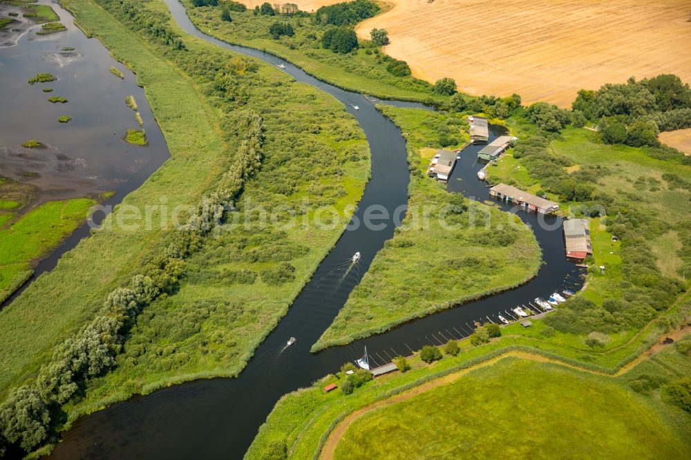 Aerial image Verchen - Boat Houses with the recreational marine jetties and boat mooring area on the banks of the river Peene in Verchen in the state Mecklenburg - Western Pomerania