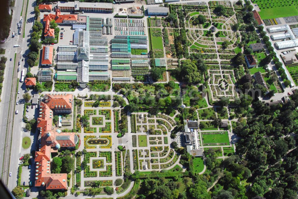 Aerial image München - Blick auf den Botanischen Garten in München-Nymphenburg. Der Botanische Garten München-Nymphenburg, mit einer Fläche von 22 ha und über 400.000 Besuchern im Jahr, gehört zu den bedeutendsten Botanischen Gärten der Welt. Rund 14.000 Pflanzenarten werden dort kultiviert. In den über 4.500 qm umfassenden Gewächshäusern können die Besucher sich auf botanische Reise in feuchttropische Gebiete, kühltropische Bergwälder oder heiße Wüsten begeben. Zusammen mit seiner Außenstation, dem Alpengarten am Schachen (1850 m), stellt er eine unentbehrliche Materialgrundlage für die Forschung dar. Er dient der Aus- und Weiterbildung, unter an derem von Gärtnerlehrlingen und von Studenten der Ludwig-Maximilians-Universität. Vom Botanischen Garten führt auch ein direkter Durchgang zum Nymphenburger Schlosspark und zum dort gelegenen Museum Mensch und Natur. Kontakt: Botanischer Garten München-Nymphenburg, Menzinger Str. 65, 80638 München, Tel.: 089/17861-310 (Sekretariat Verwaltung)