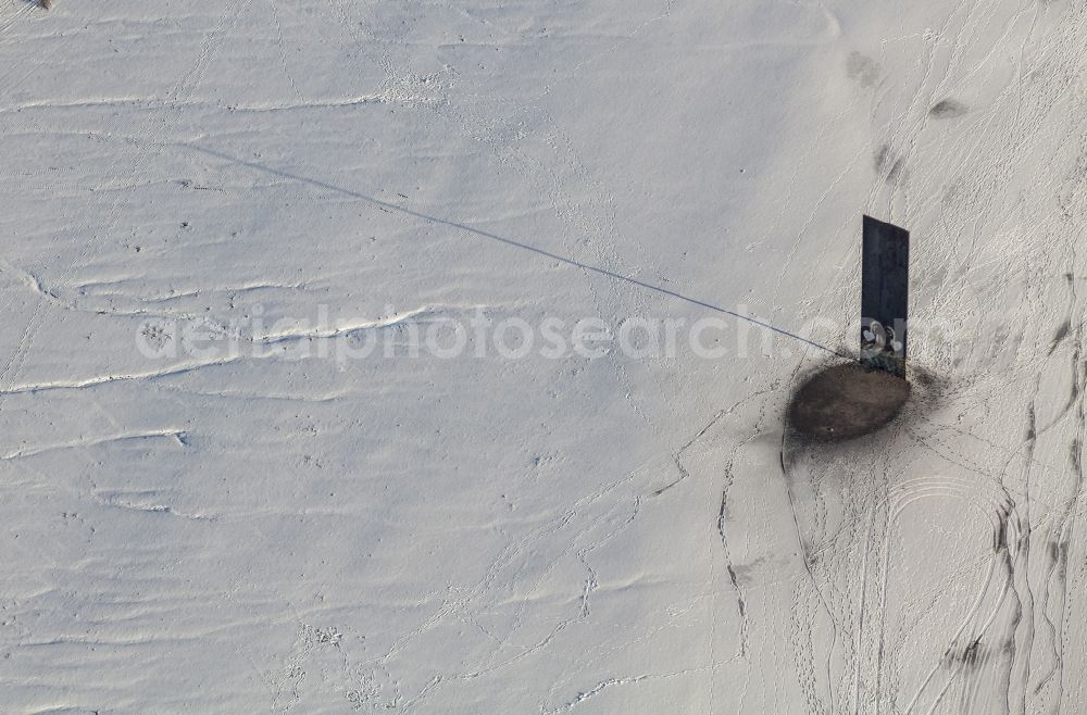 Aerial photograph Essen - Skelp for the Ruhr region in the snow covered Schurenbachhalde (former pit) in Essen in the state of North Rhine-Westphalia. The minimalist sculpture by American artist Richard Serra was put in place in 1998. It is widely visible because of its height