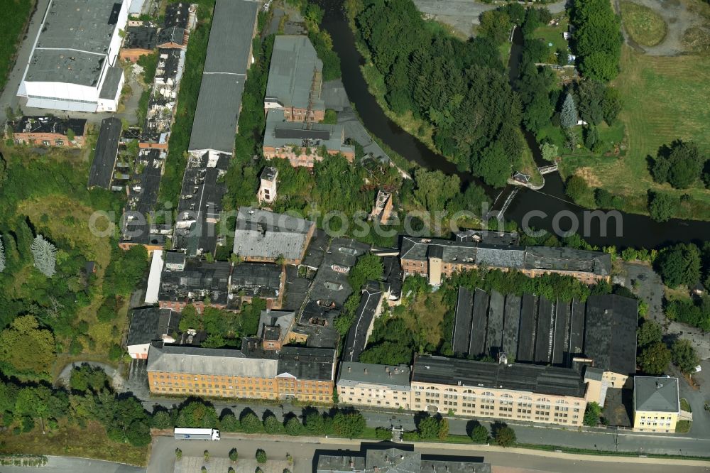 Aerial photograph Oelsnitz/Vogtl. - Fire Ruin the buildings and halls of the former VEB Halbmond carpet works on Carl-Wilhelm-Koch-Strasse in Oelsnitz/Vogtl. in the state of Saxony