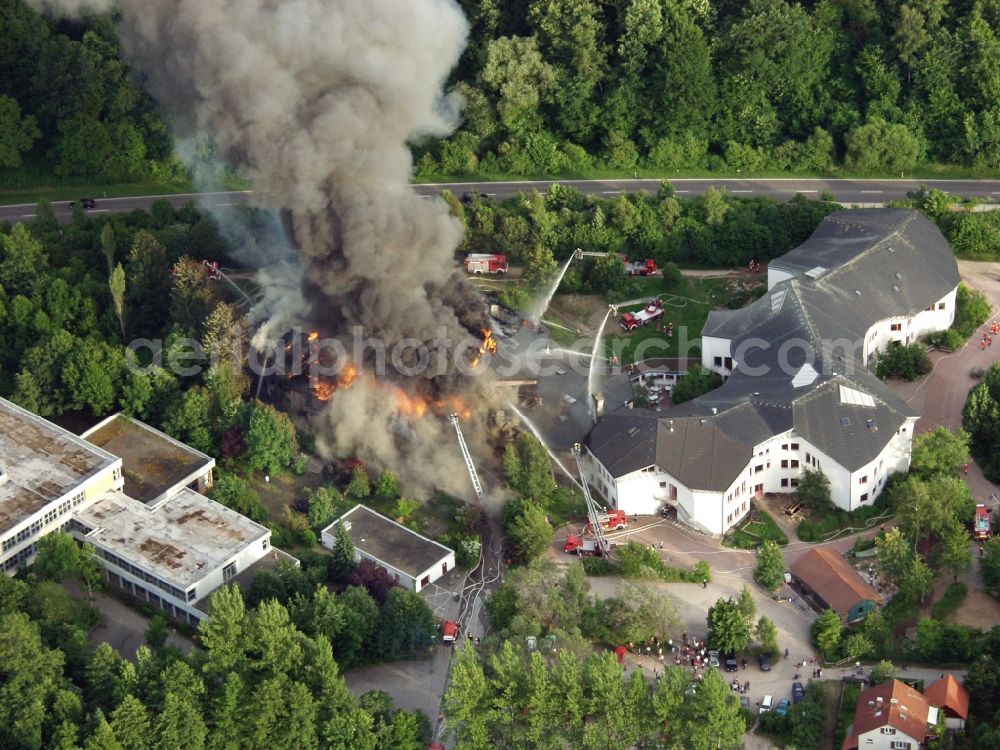 Schopfheim from the bird's eye view: Large fire at the gym of the Waldorf School in Schopfheim in Baden-Wuerttemberg. The fire department in operation. The smoke cloud passes over the residential area