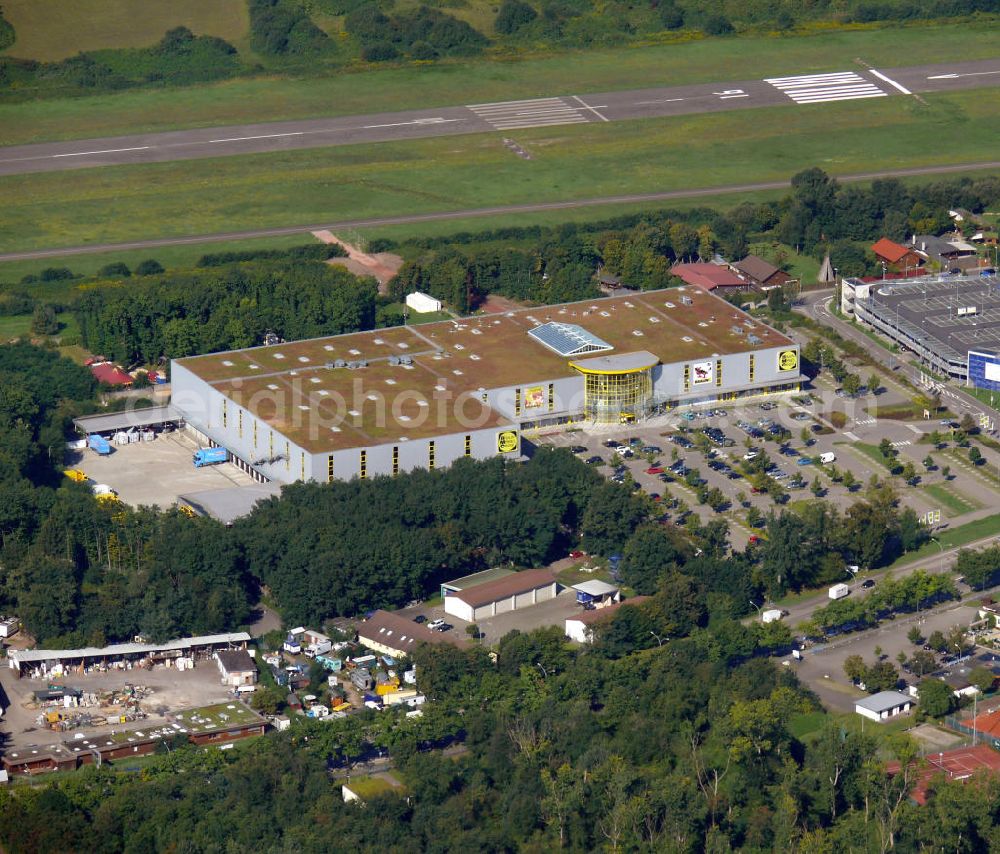 Aerial image Freiburg - Das Braun Möbel Center an der Herrmann-Mitsch-Straße in unmittelbarer Nähe zum Flugplatz im Stadtteil Brühl in Freiburg, Baden-Württemberg. The furniture store Braun Möbel Center at the street Herrmann Mitsch Strasse in close vicinity to the airfield in the district Bruehl in Freiburg, Baden-Wuerttemberg.