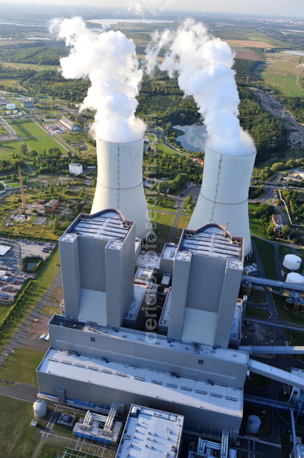 Lippendorf from the bird's eye view: Gelände des Kraftwerk Lippendorf, ein mit Braunkohle befeuertes Heizkraftwerk / Dampfkraftwerk im Nordwestrand des Ortes Lippendorf der Gemeinde Neukieritzsch im Landkreis Leipzig. Die beiden Dampferzeuger und Kesselhäuser sind knapp 165 Meter hoch. Betreiber und neben der EnBW Energie Baden-Württemberg AG auch Eigentümer des Kraftwerks ist die Vattenfall Europe Generation AG. Area of fueled by brown coal power plant Lippendorf in municipality Neukieritzsch in administrative district Leipzig. The two steam generators and boiler houses are nearly 165 metres high. The heat and steam power plant is owned by power supply companies EnBW Energie Baden-Württemberg and Vattenfall Europe Generation AG, who is also the operator.