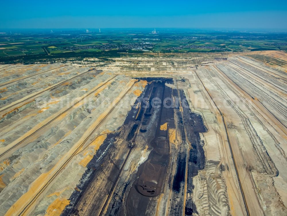 Niederzier from the bird's eye view: Mining area - terrain and overburden surfaces of coal - opencast mining in Niederzier in the state North Rhine-Westphalia