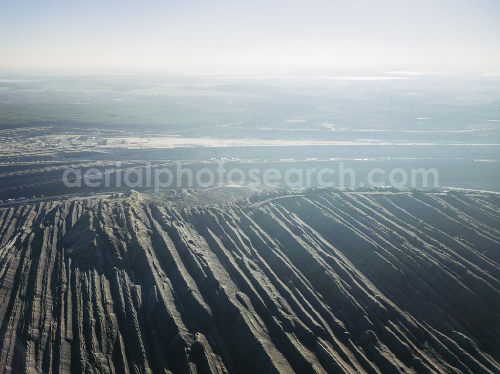 Welzow from the bird's eye view: Mining area - terrain and overburden surfaces of coal - opencast mining of Vattenfall Europe in Welzow in the state Brandenburg