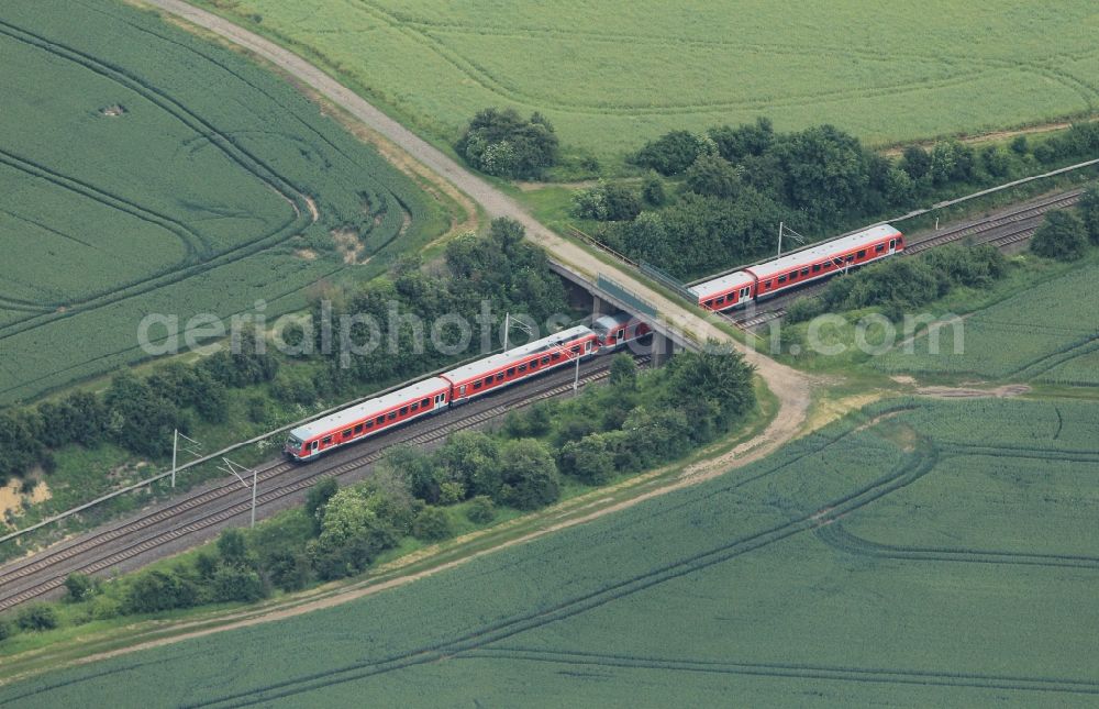 Niederzimmern from the bird's eye view: South of Niederzimmern in Thuringia is this bridge over the railway tracks of the mainline and regional train. Just a passenger train crossed the bridge