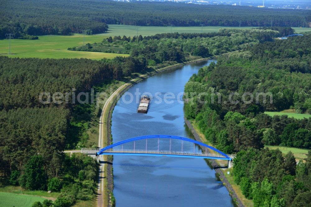 Burg (bei Magdeburg) from above - Bridge over the Elbe-Havel-Kanal in the West of the town of Burg (bei Magdeburg) in the state of Saxony-Anhalt. The distinct blue arc bridge spans the canal in the West of the town. The bridge is surrounded by forest and is one of several bridges on the canal