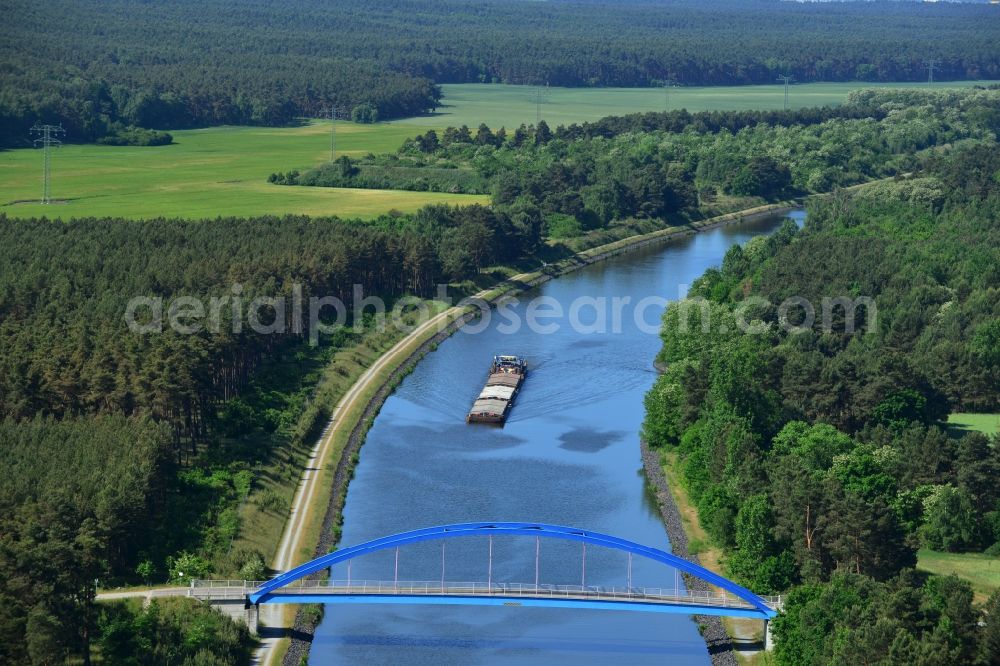 Burg (bei Magdeburg) from the bird's eye view: Bridge over the Elbe-Havel-Kanal in the West of the town of Burg (bei Magdeburg) in the state of Saxony-Anhalt. The distinct blue arc bridge spans the canal in the West of the town. The bridge is surrounded by forest and is one of several bridges on the canal