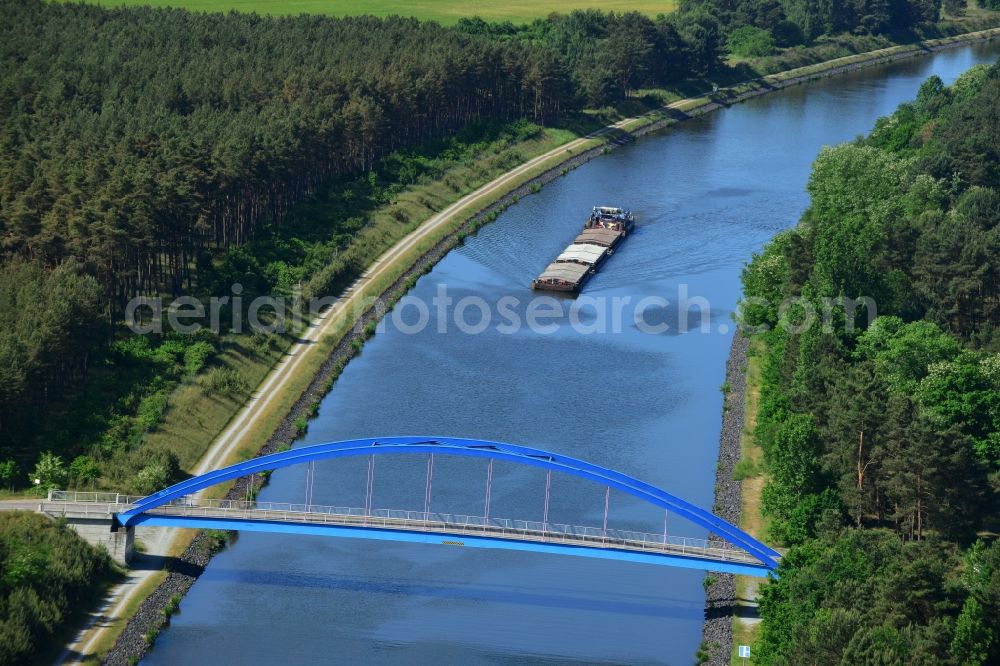 Aerial image Burg (bei Magdeburg) - Bridge over the Elbe-Havel-Kanal in the West of the town of Burg (bei Magdeburg) in the state of Saxony-Anhalt. The distinct blue arc bridge spans the canal in the West of the town. The bridge is surrounded by forest and is one of several bridges on the canal